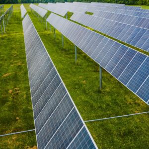 Solar modules on green field in photovoltaic station